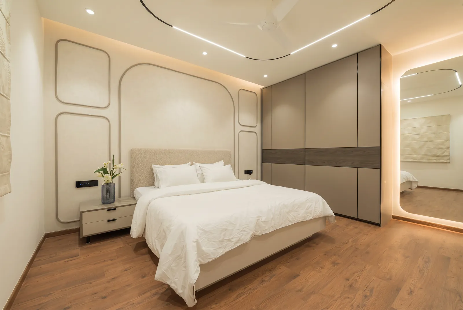 A bedroom with a sliding wardrobe in taupe matt with a smoked-oak band.