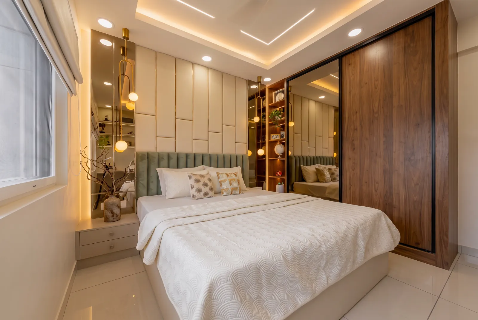 A bedroom with a sliding wardrobe in walnut and bronze glass and a sage velvet headboard.