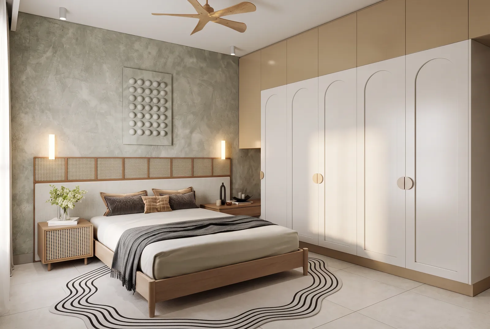 A bedroom with an ivory PU wardrobe with routed arch doors and half-moon pulls, glossy beige lofts above, and a cane-fronted bedside table.